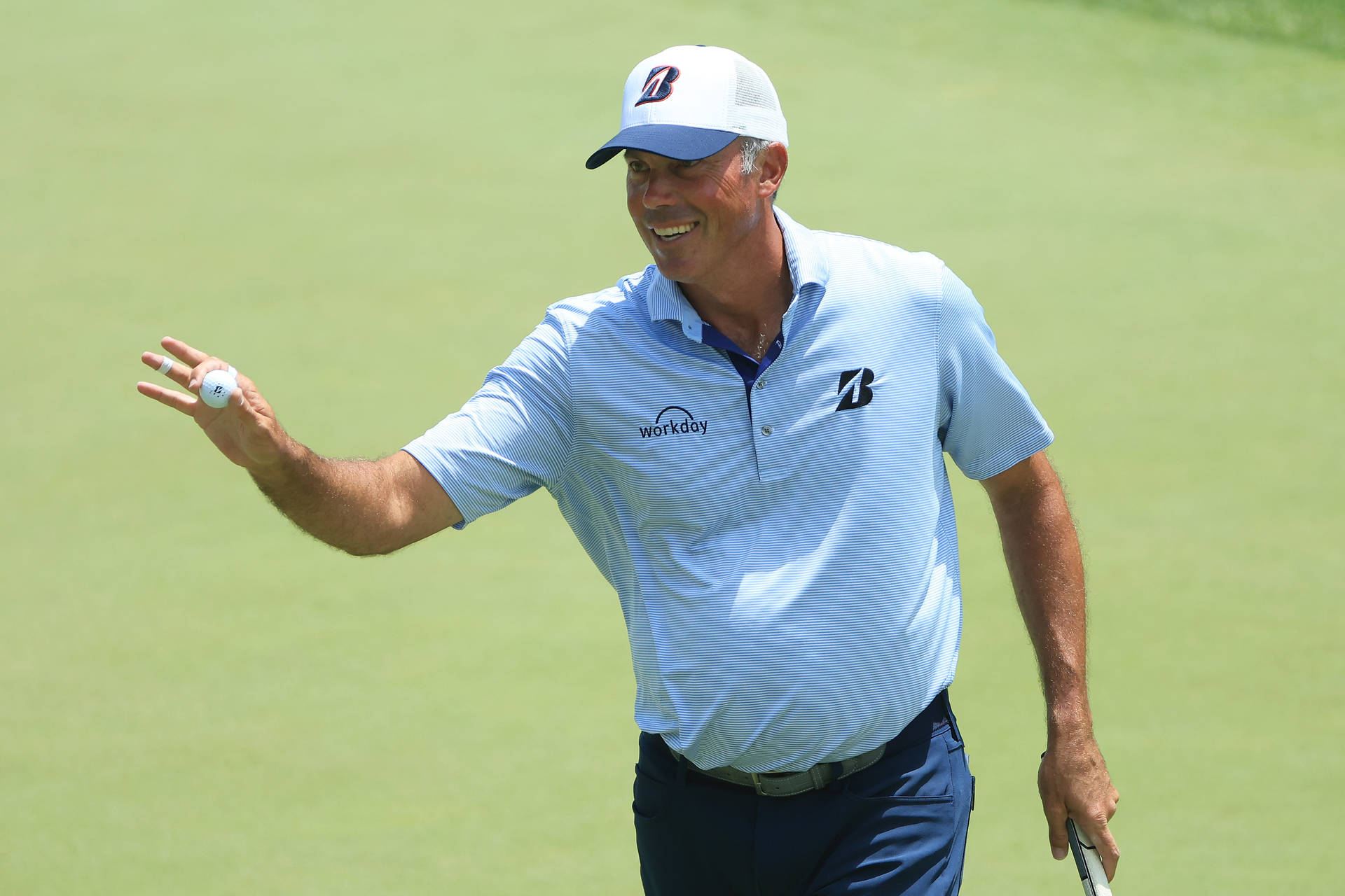 Matt Kuchar Proudly Showing Golf Ball Background