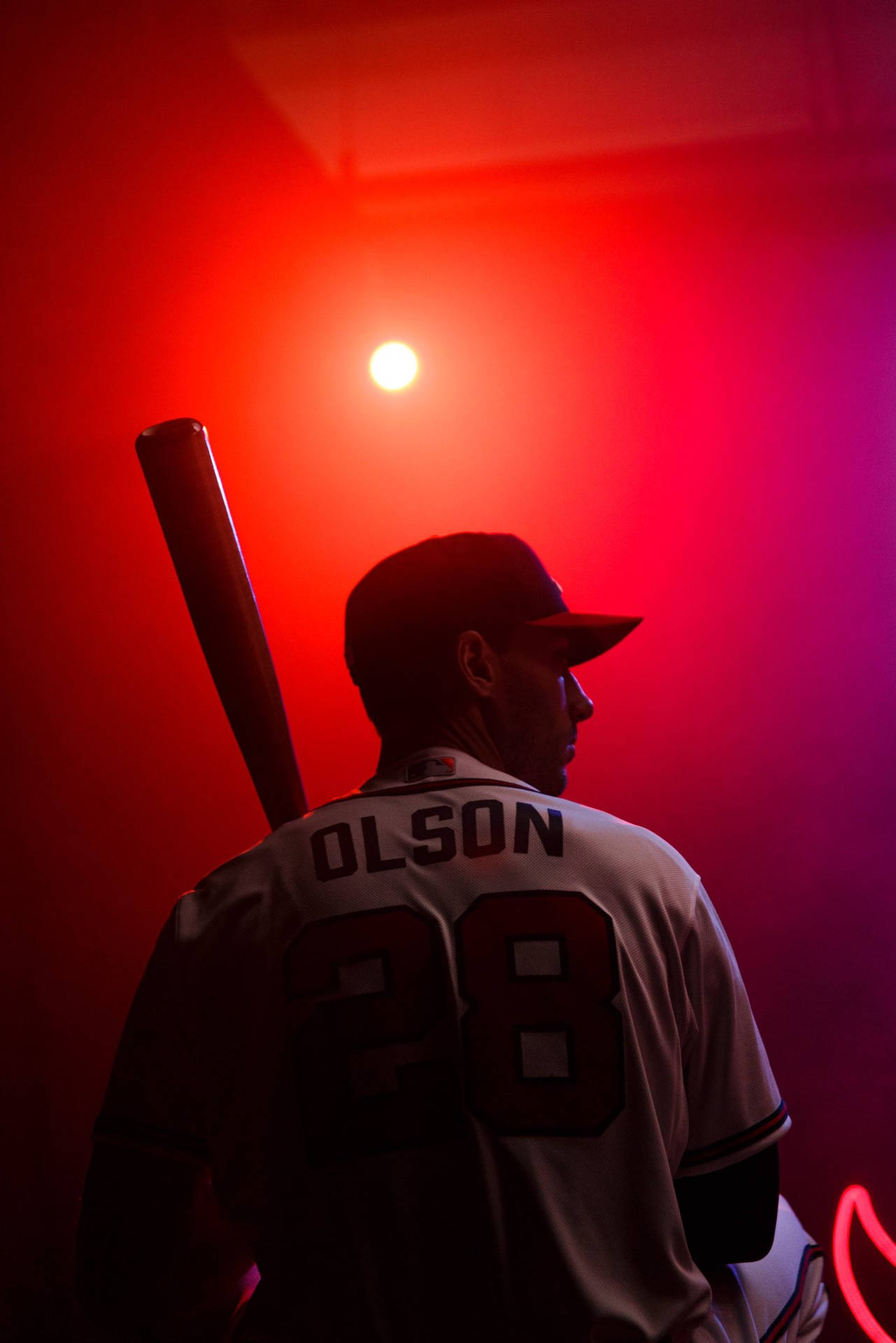 Matt Olson Holding Bat Red Light Background