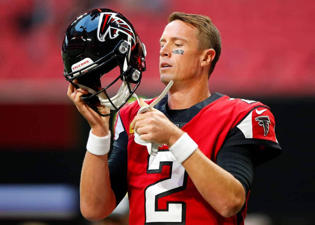 Matt Ryan Fixing A Helmet Background