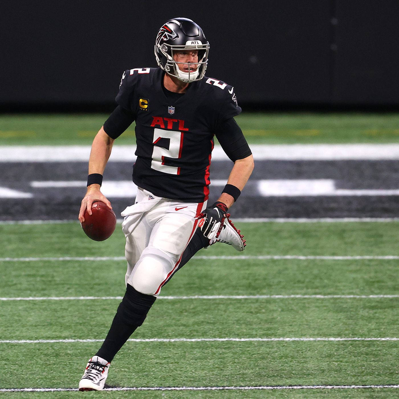 Matt Ryan Running And Holding A Ball Background