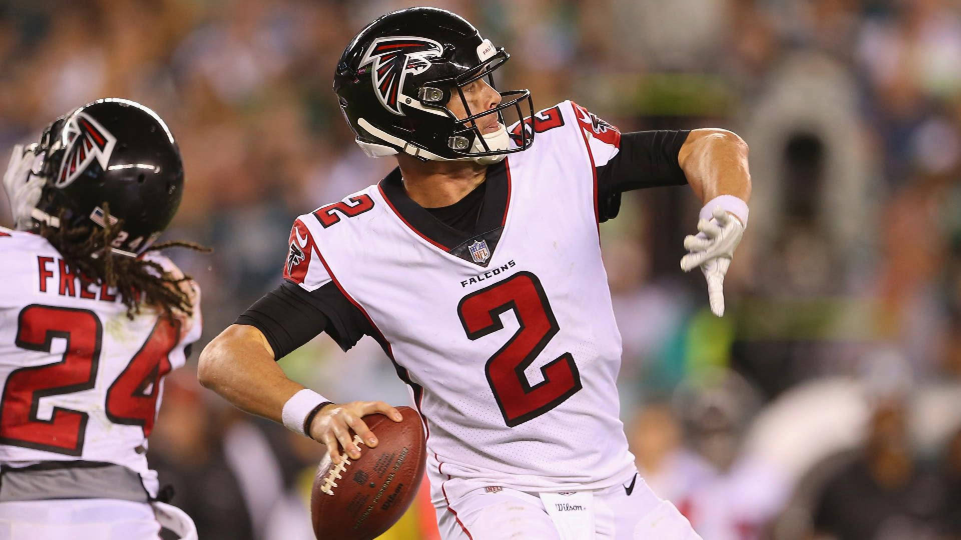 Matt Ryan Throwing A Ball In White Jersey Background