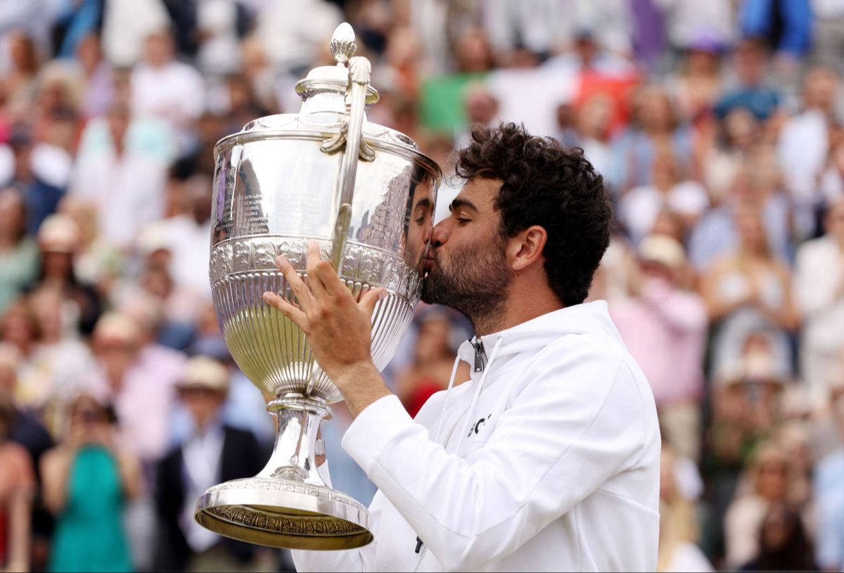 Matteo Berrettini Celebrates Victory With A Trophy Kiss Background