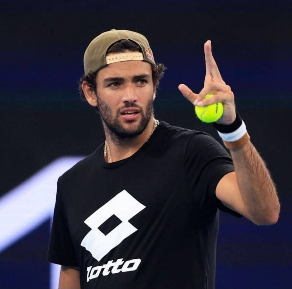 Matteo Berrettini Holding A Tennis Ball Background