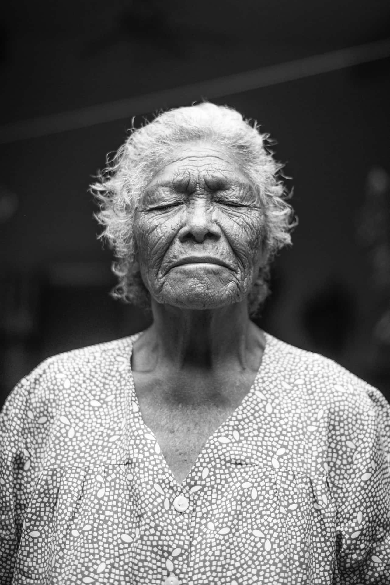 Mature Old Woman Closing Her Eyes