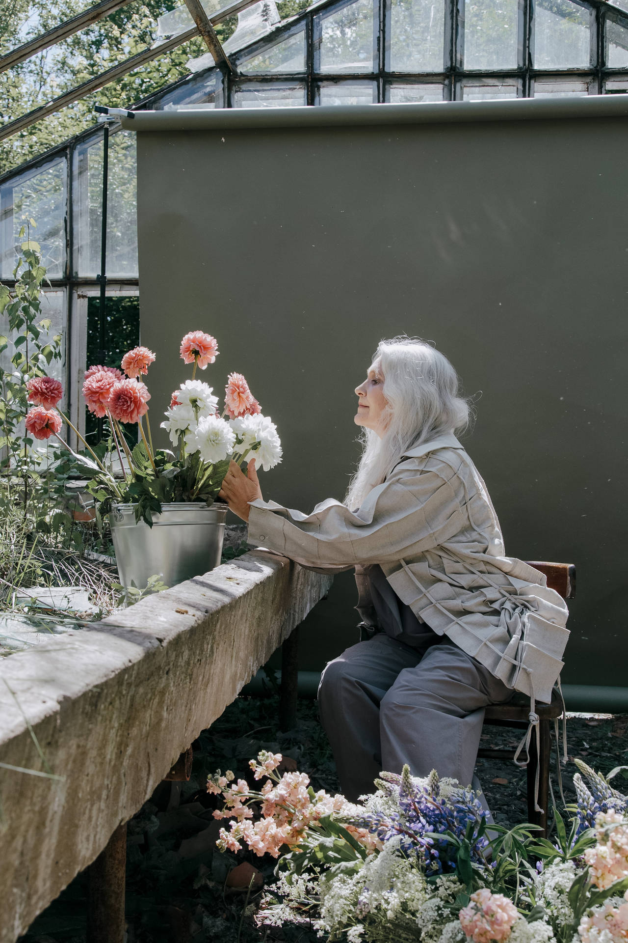 Mature Woman Arranging Flowers Background