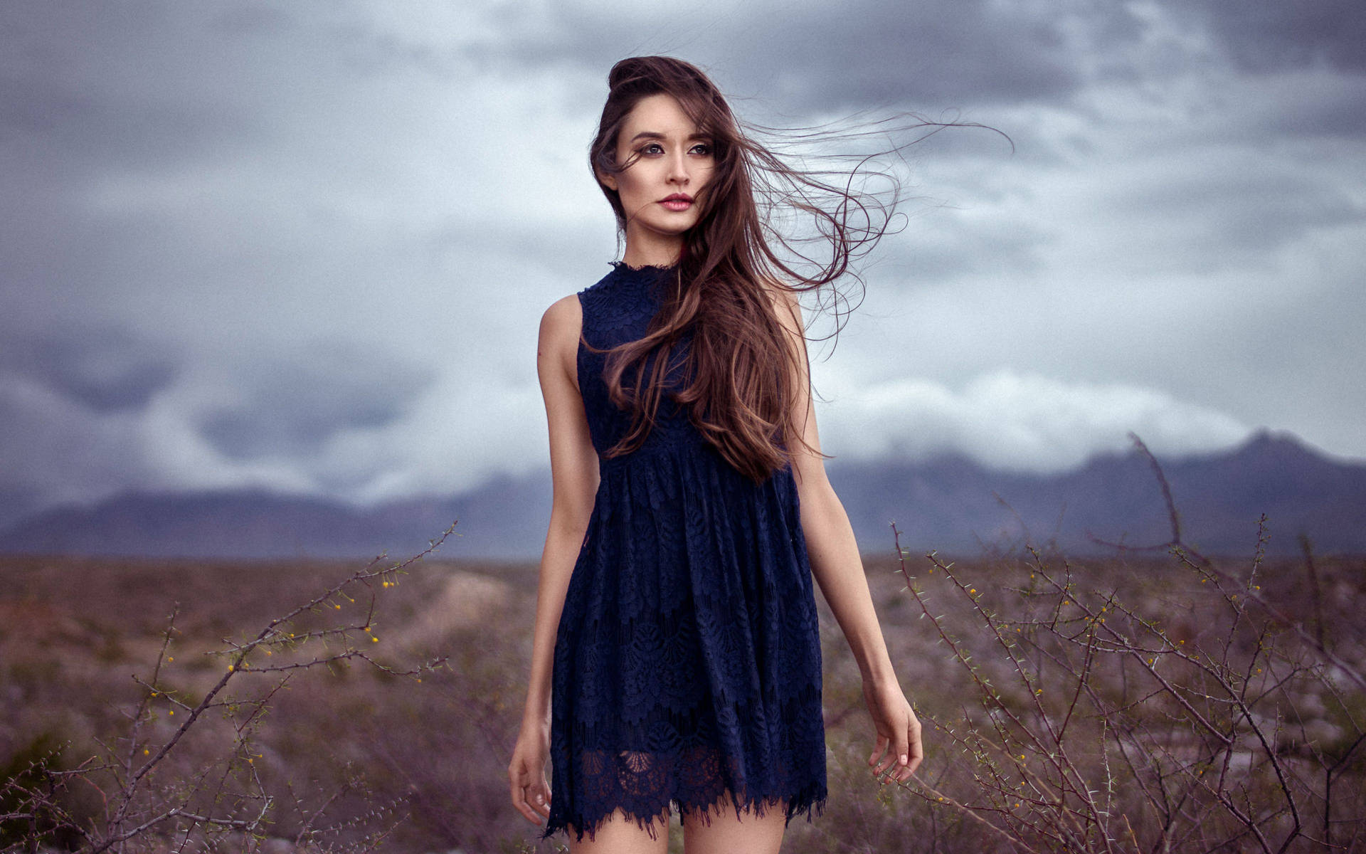 Mature Woman In The Stormy Desert Background