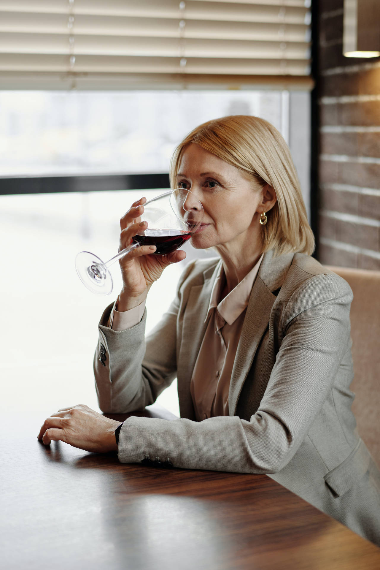 Mature Woman Sipping Wine Background