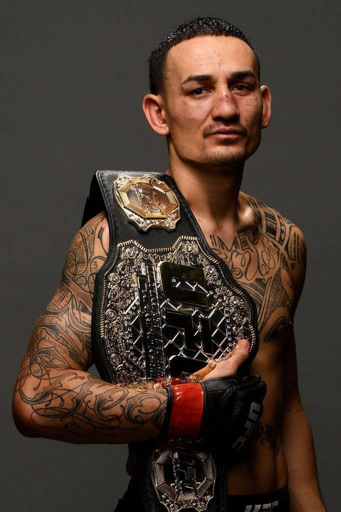 Max Holloway Holding Belt Background