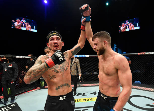 Max Holloway Raising Opponent Hand