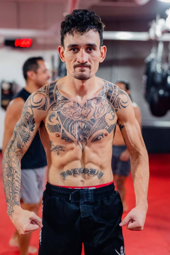 Max Holloway Strong In Gym Background