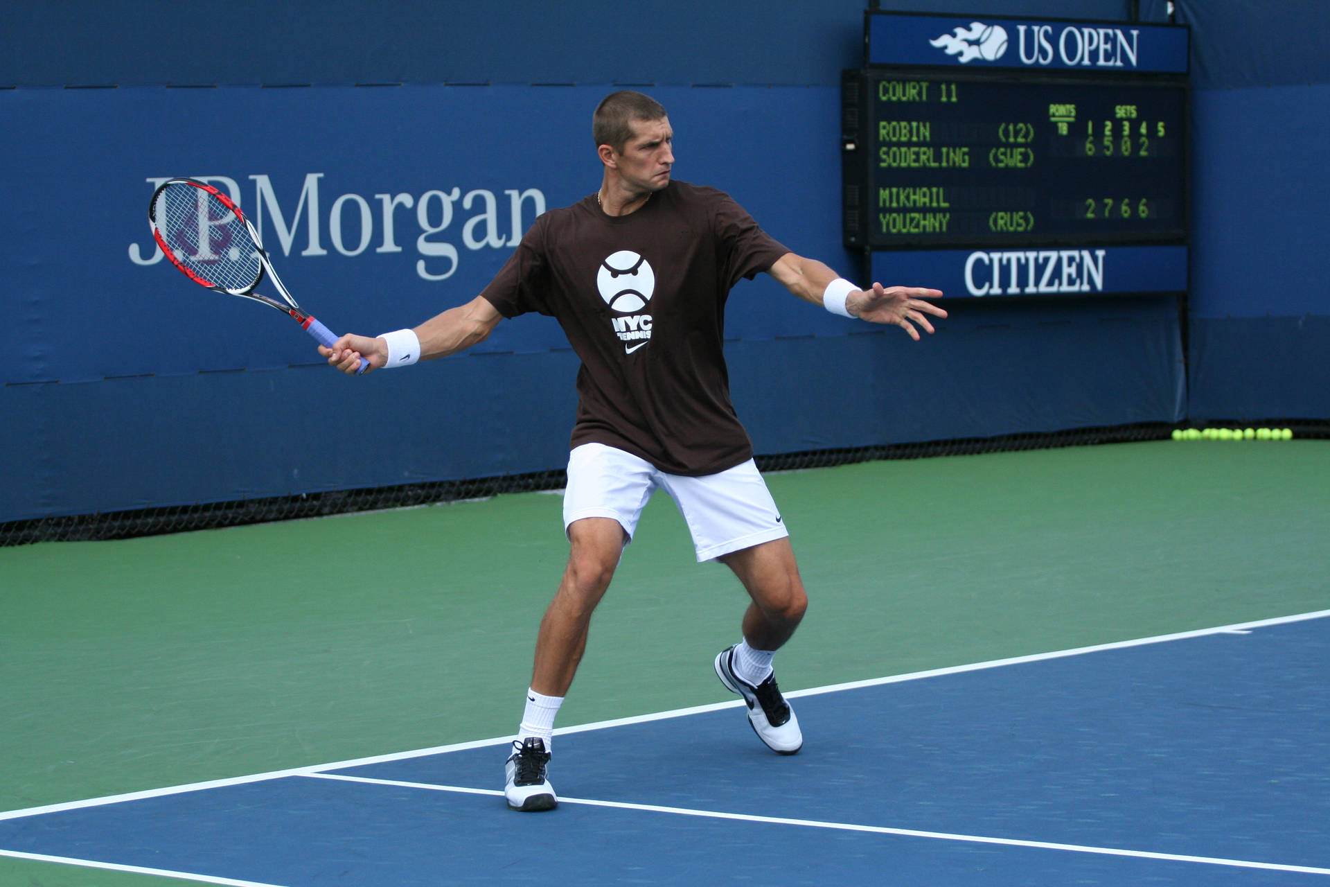 Max Mirnyi Executing A Strategic Angling Shot During The Us Open Match Background