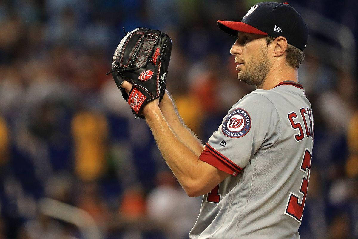 Max Scherzer With Baseball Gloves Background