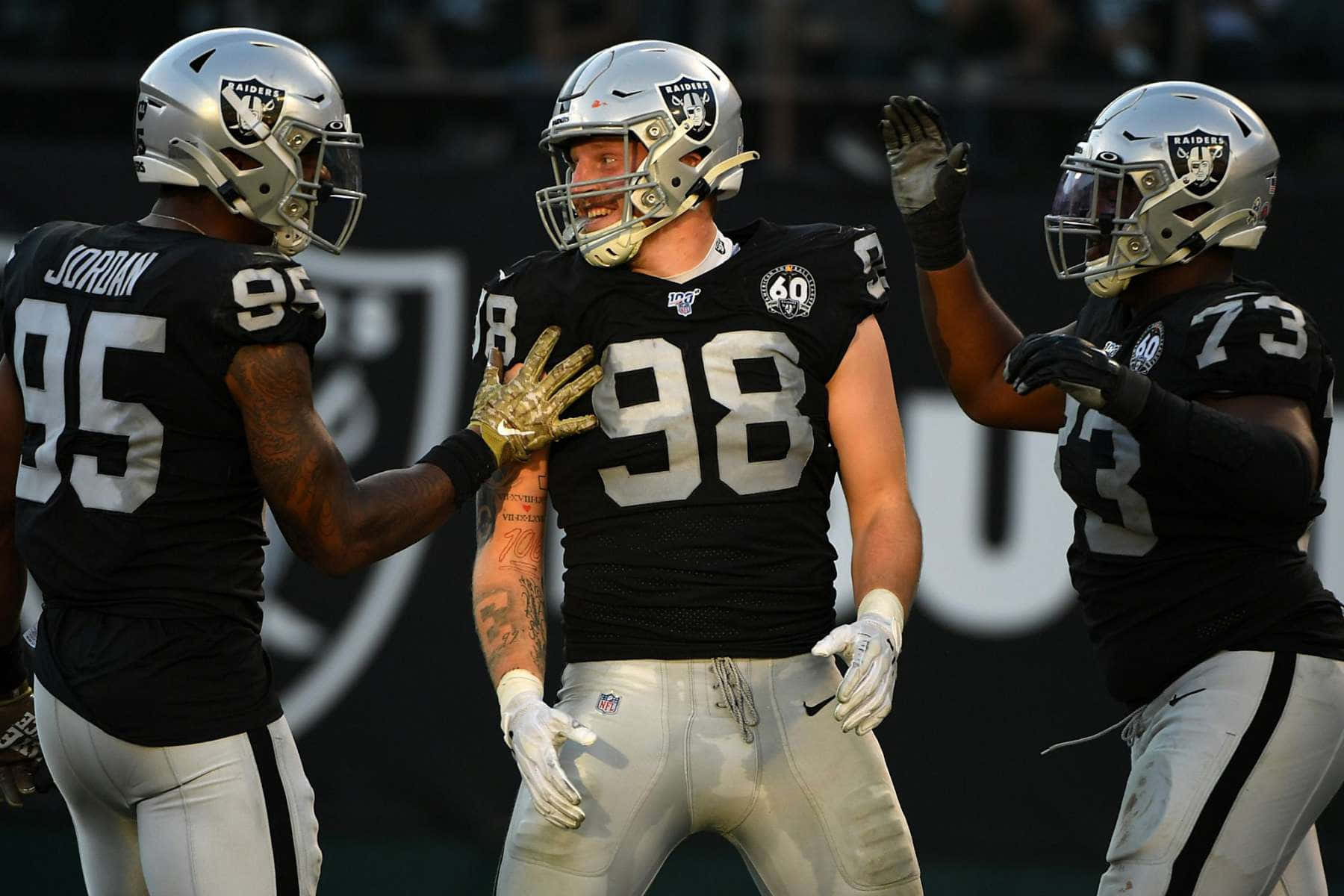 Maxx Crosby Celebrating With Raiders Teammates. Background