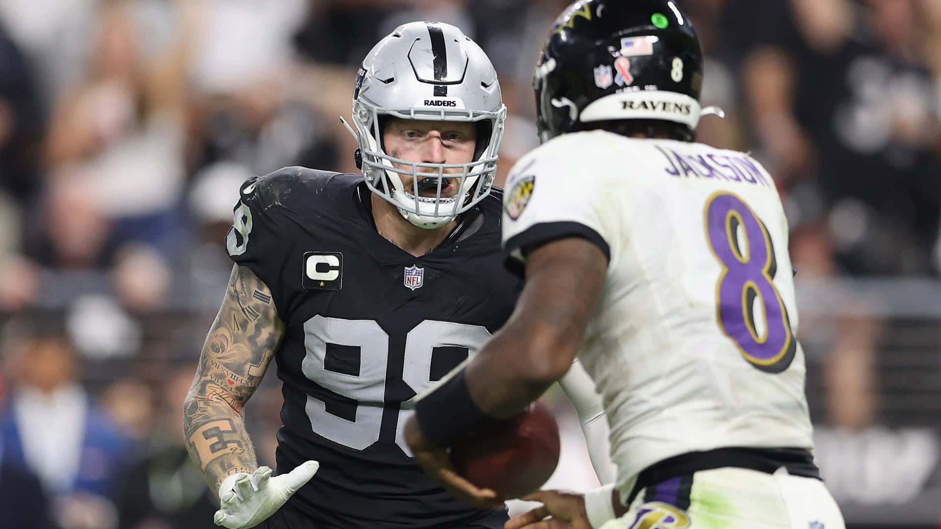 Maxx Crosby Facing Ravens Lamar Jackson Background