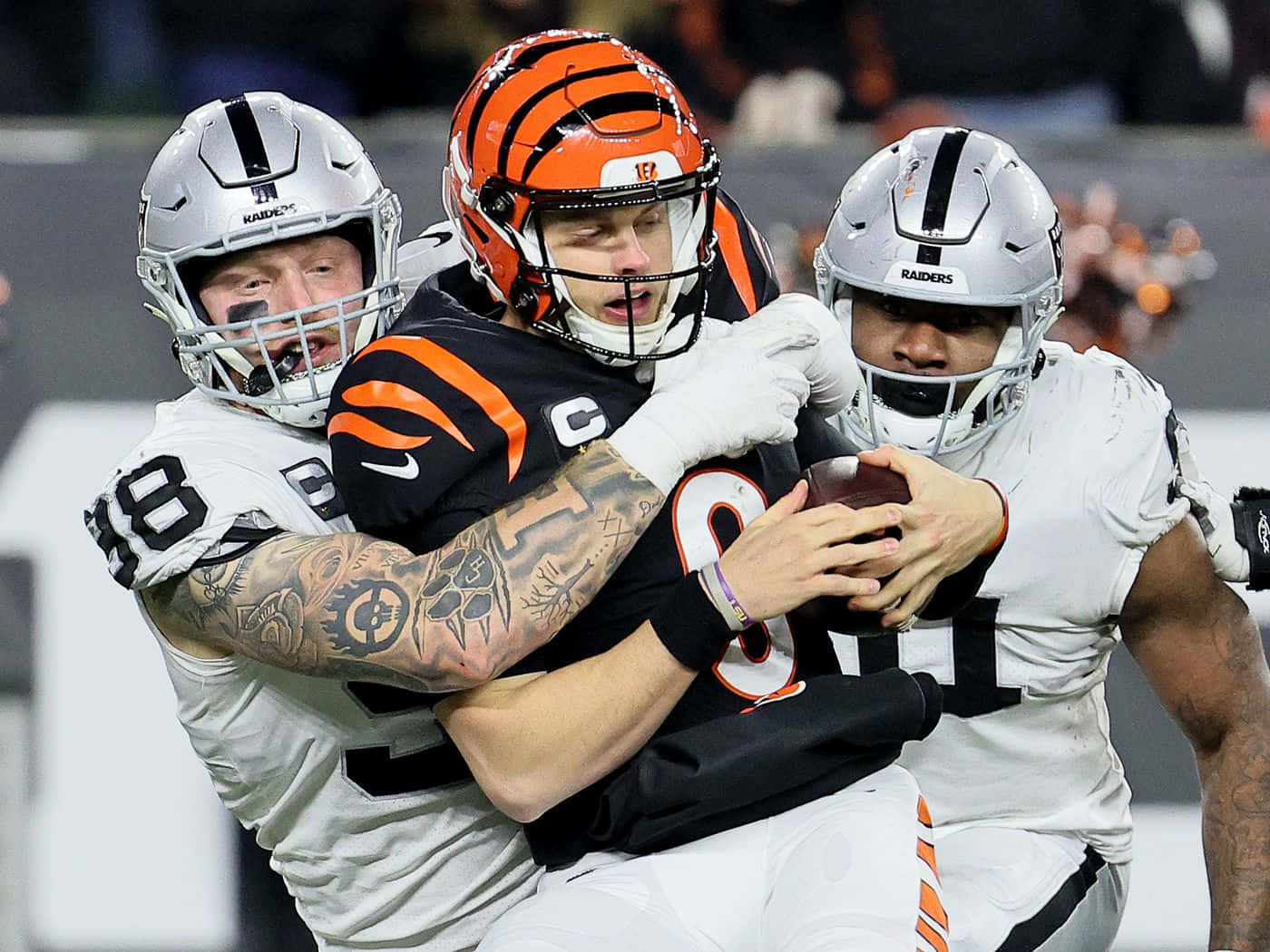 Maxx Crosby Tackling Joe Burrow Background