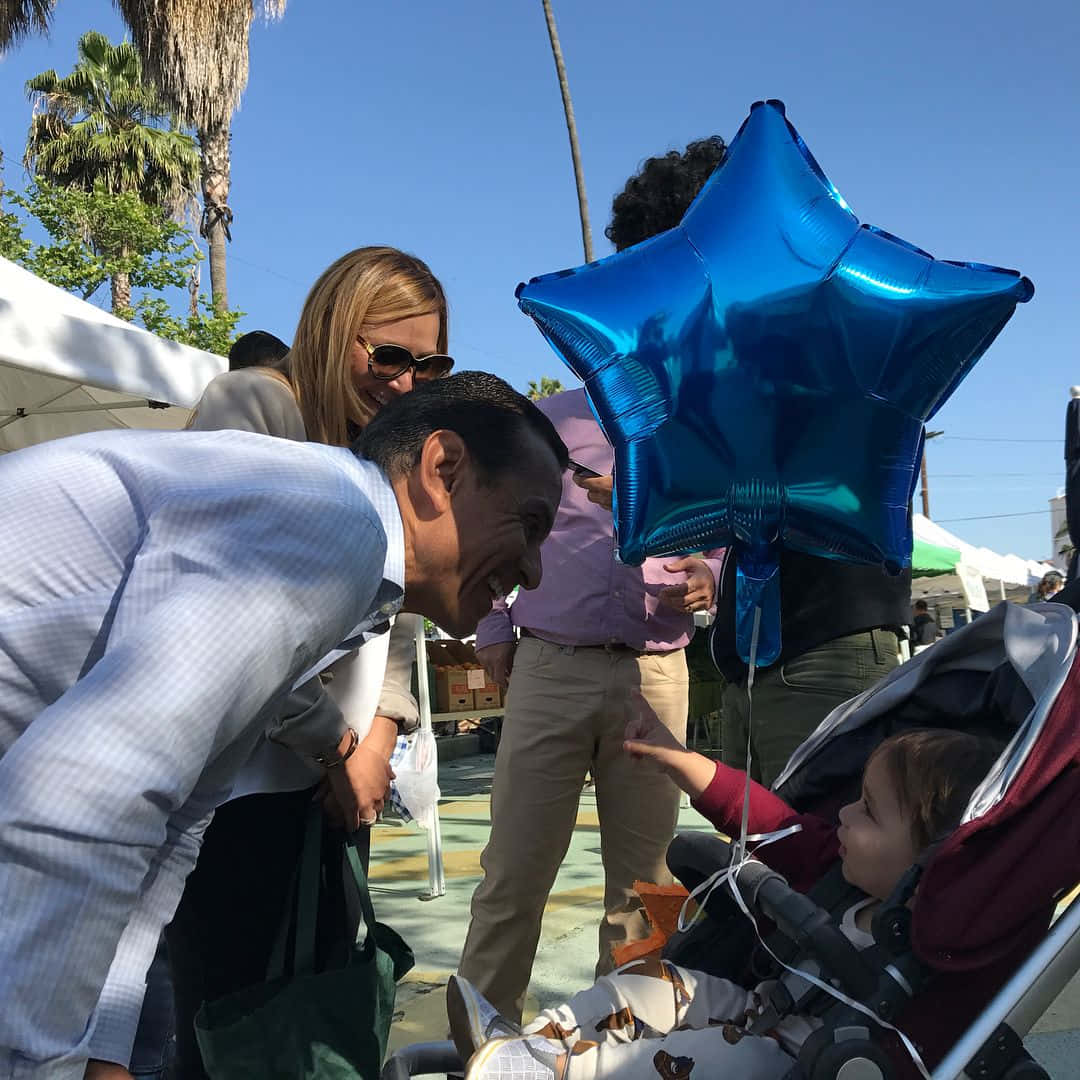 Mayor Antonio Villaraigosa Smiles As He Shares An Inspiring Story With A Young Fan. Background