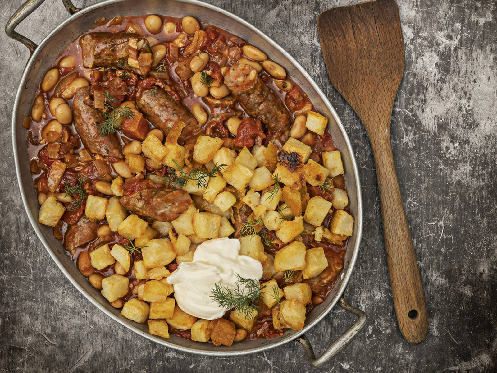 Meat Sausage Cassoulet With Potatoes And Sour Cream Background