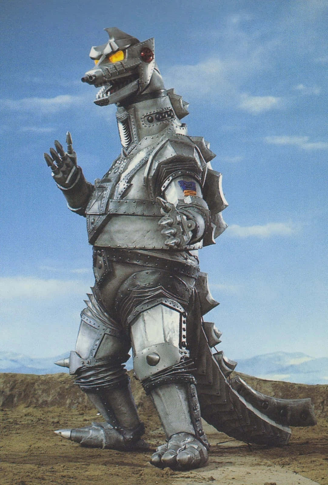 Mechagodzilla, The Powerful Robotic Titan, Stands Tall Against A Flaming Backdrop. Background