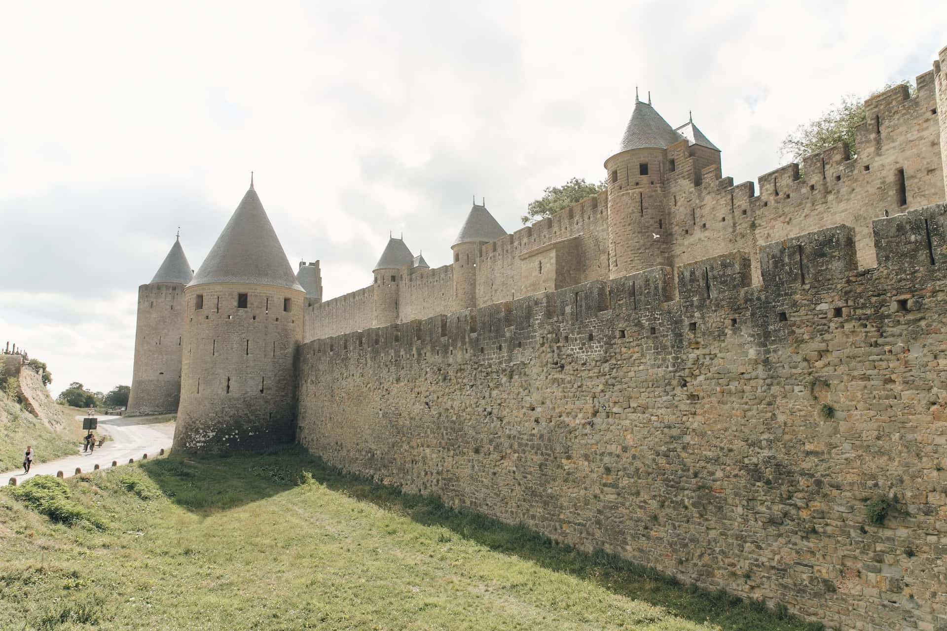 Medieval Walls Of Chateau Comtal In Carcassonne Background