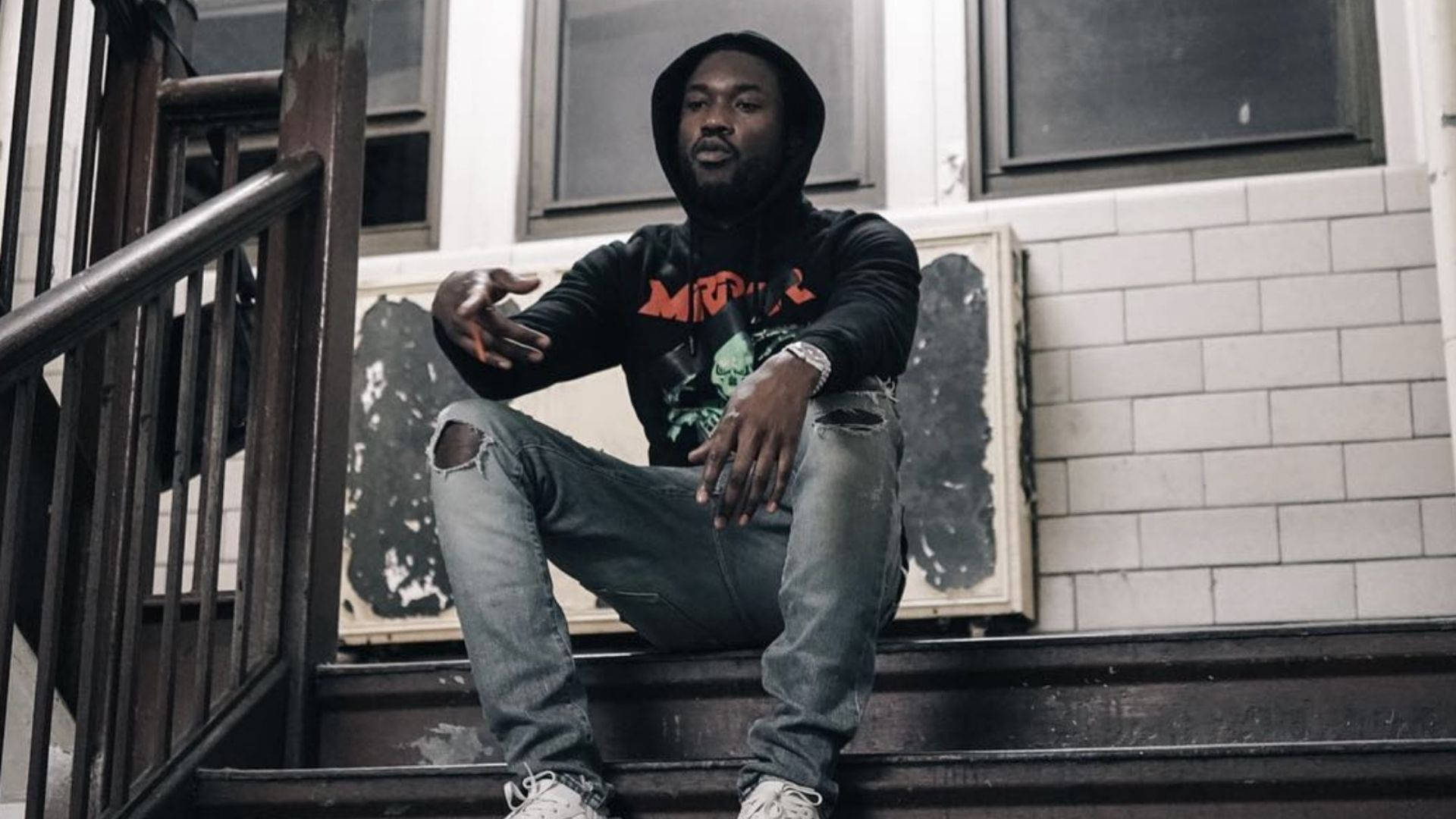 Meek Mill Posing On A Grand Staircase Background