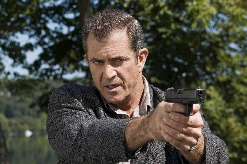 Mel Gibson Holding Gun Background
