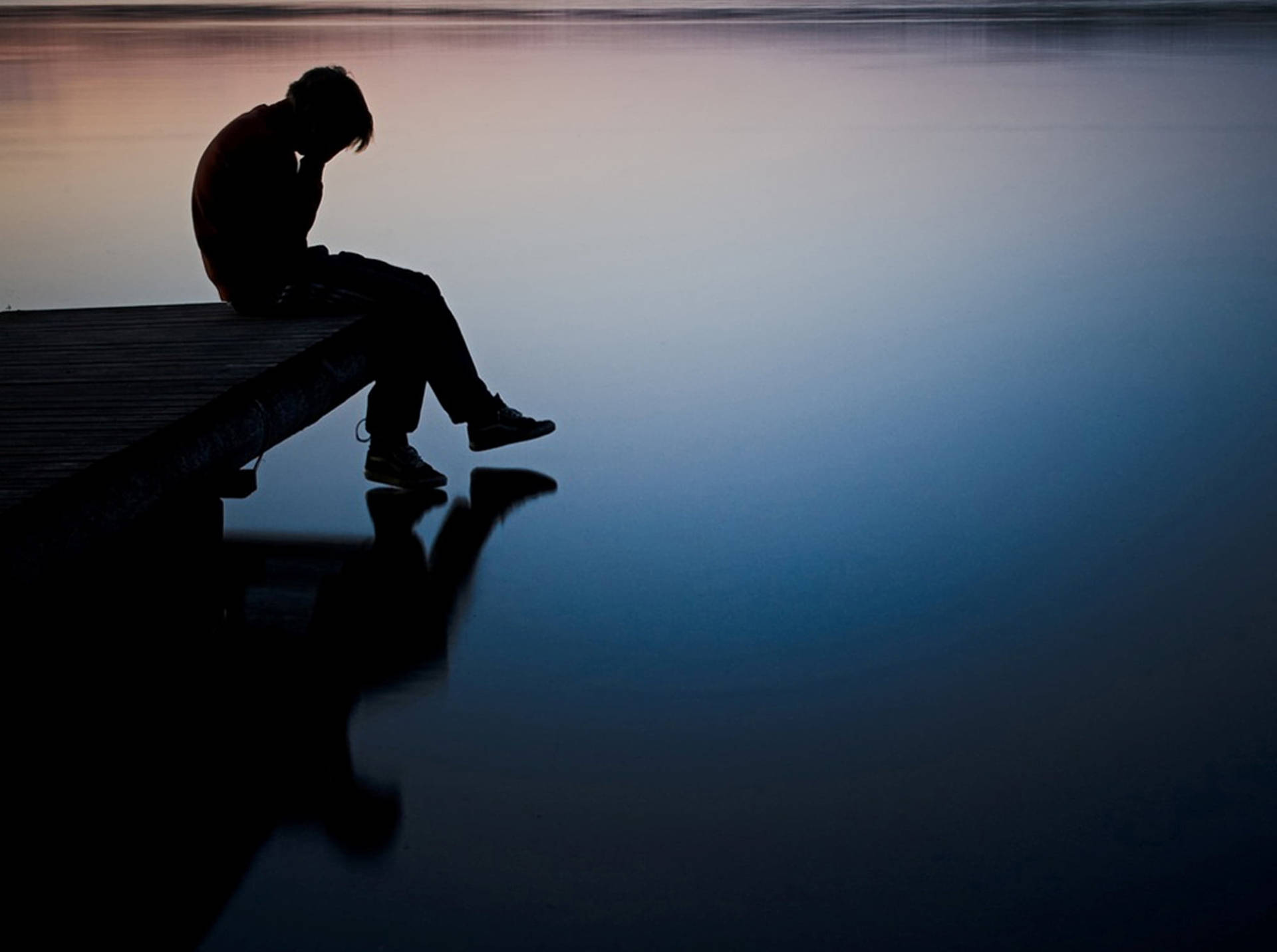 Melancholy Silhouette By The Water Background