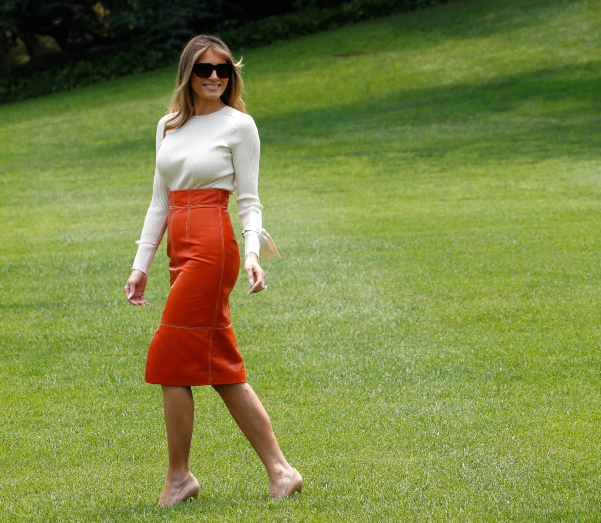 Melania Trump In Orange Skirt Background