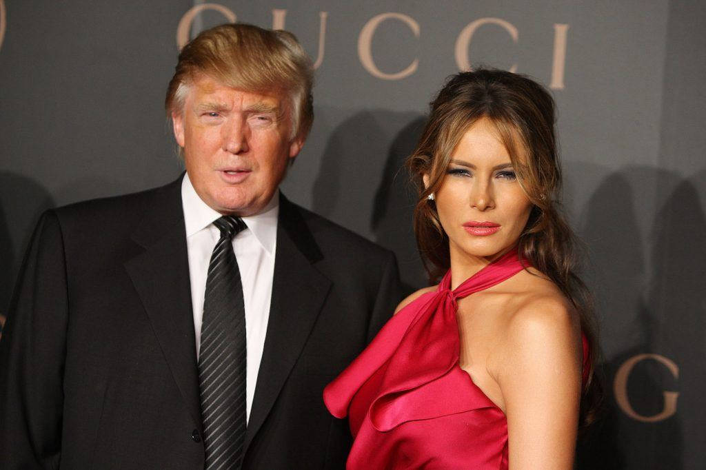 Melania Trump In Red With Donald Background