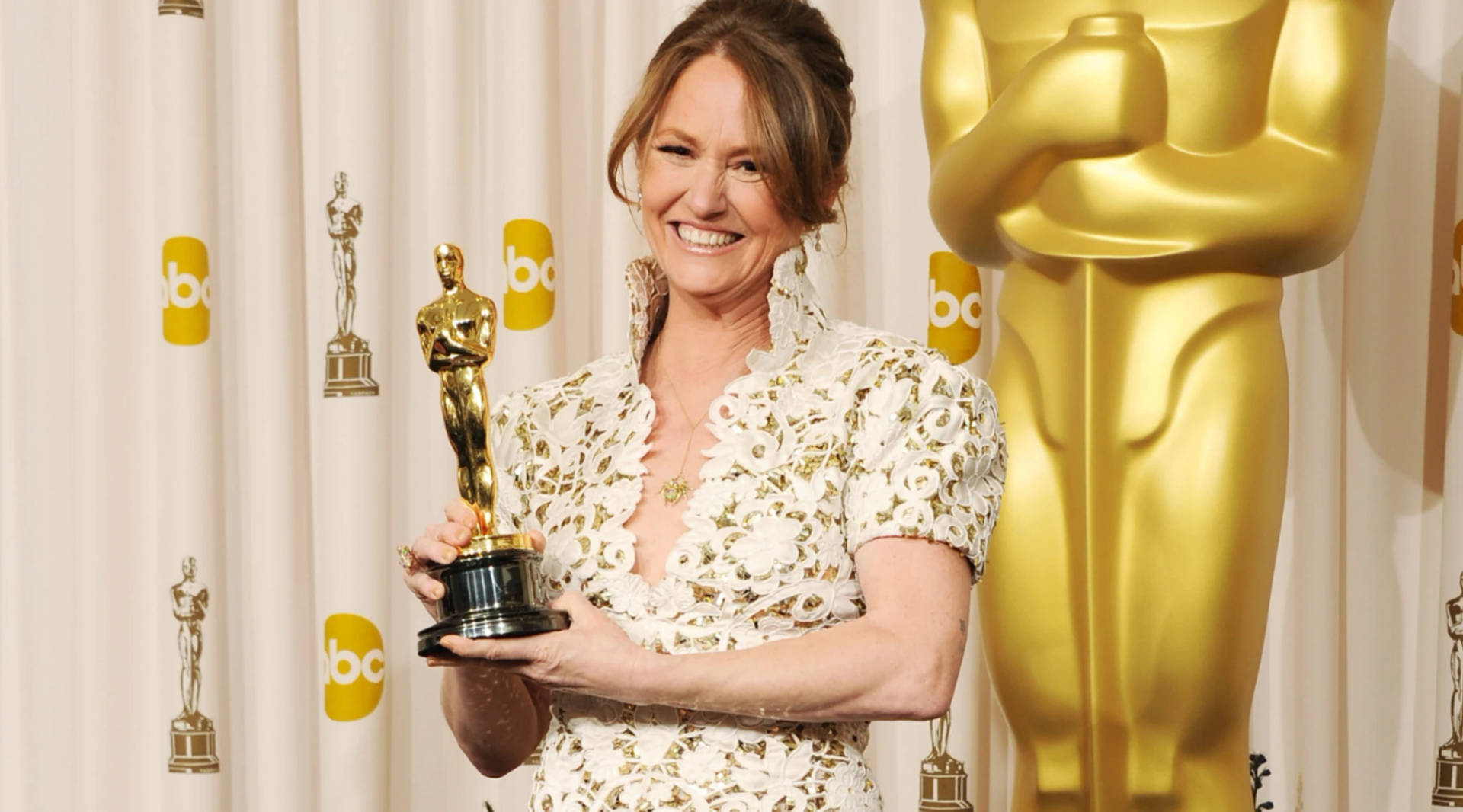 Melissa Leo Triumphantly Holding Her Oscar Trophy. Background