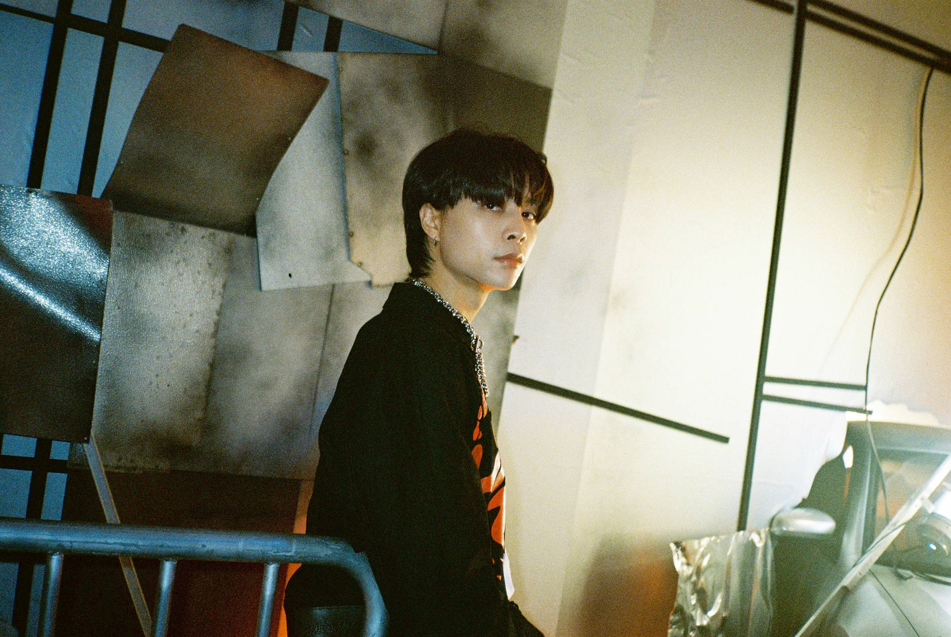 Member Of Nct 127, Johnny, Captured In A Vivid Portrayal Against An Earthquake Image Backdrop.