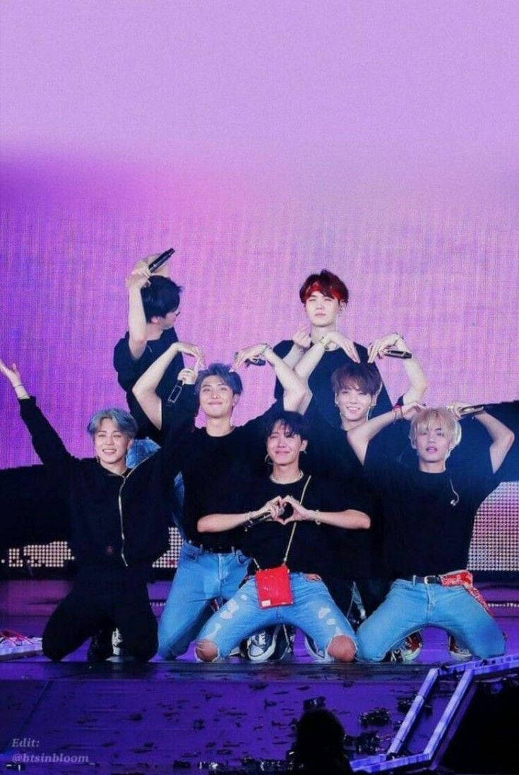 Members Doing Heart Poses In Their Bts Concert Background