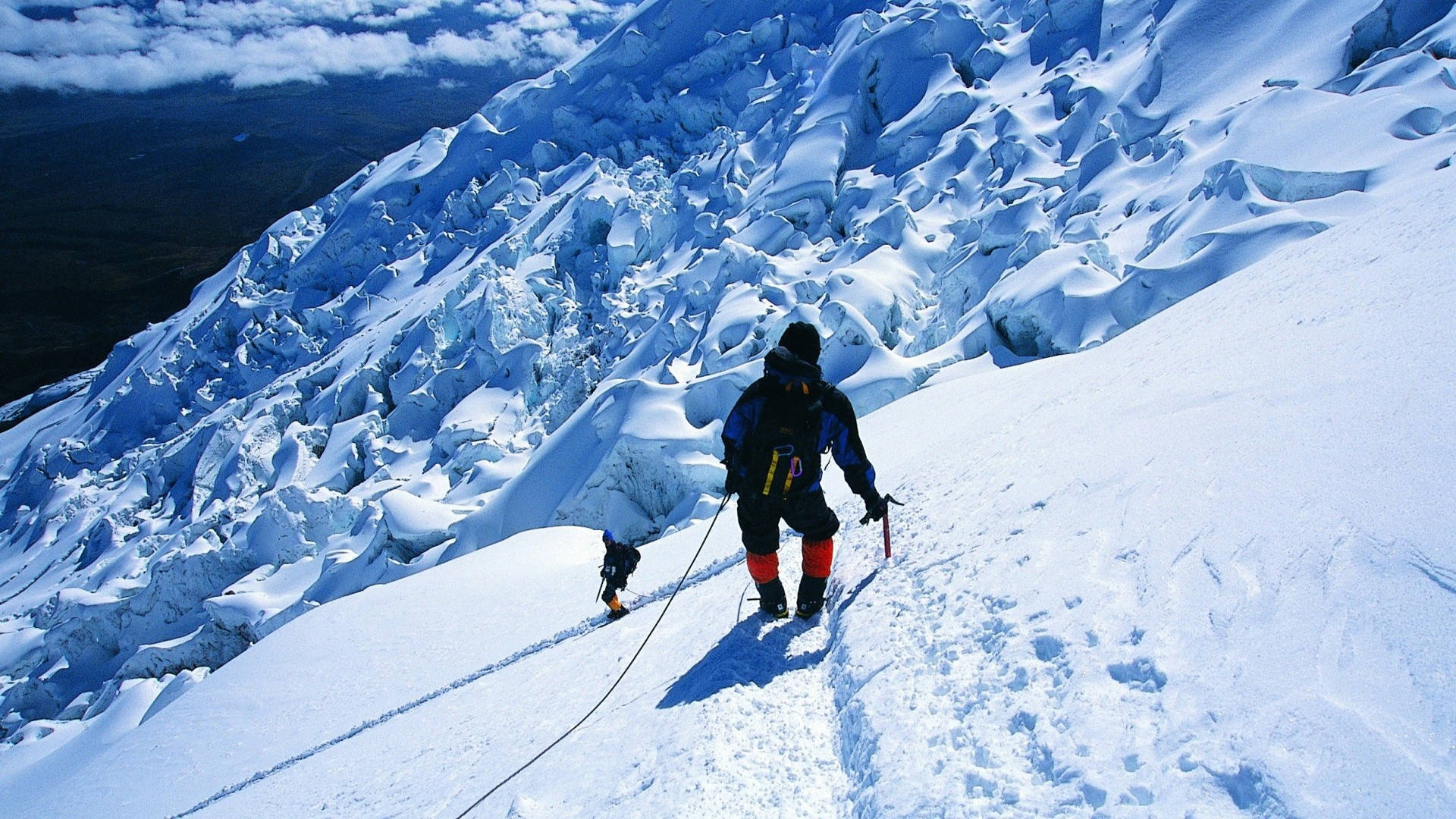 Men Climbing An Icy Rock Mountain