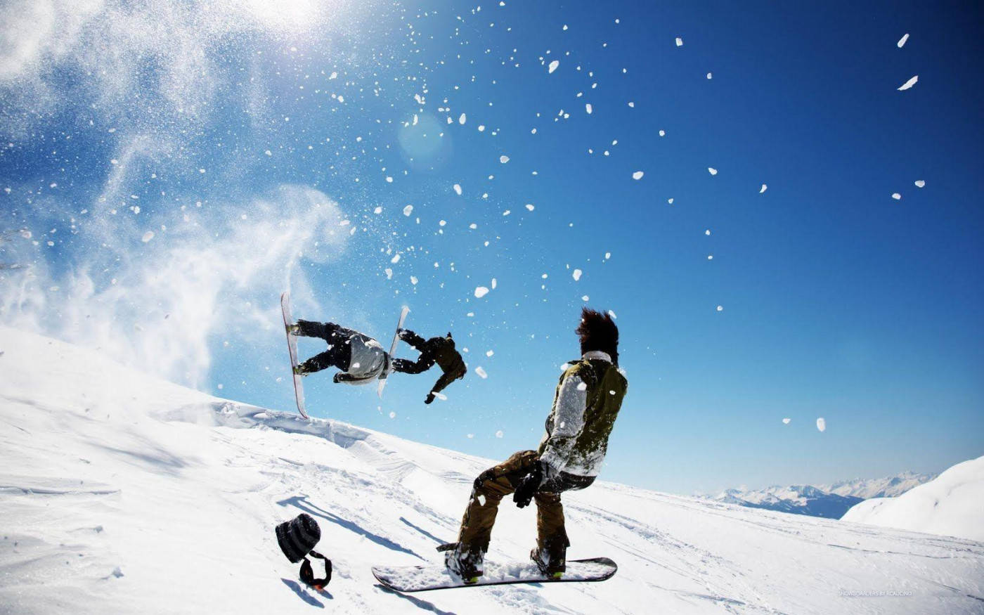 Men Doing Tricks With Snowboard