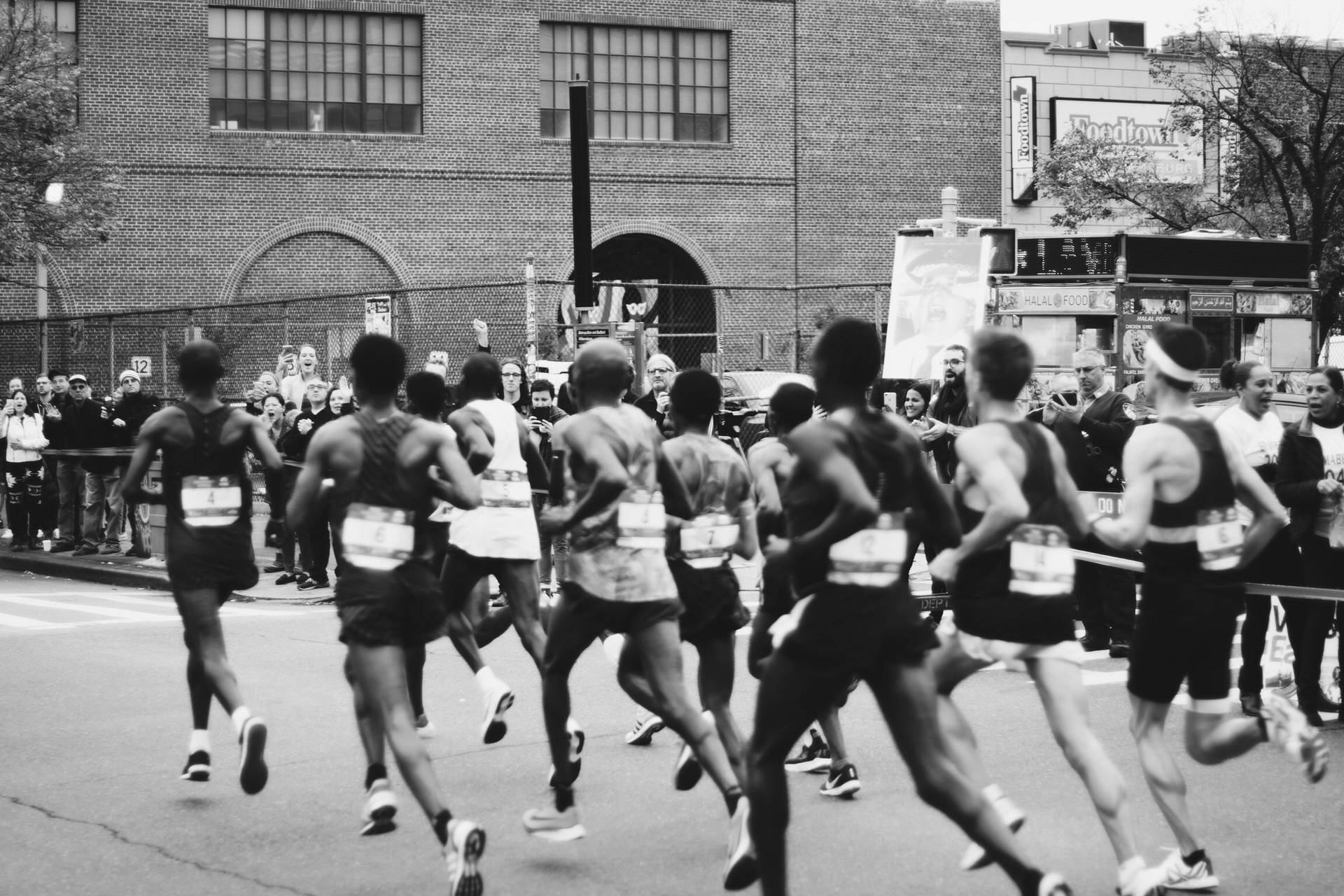 Men Running In Marathon Background