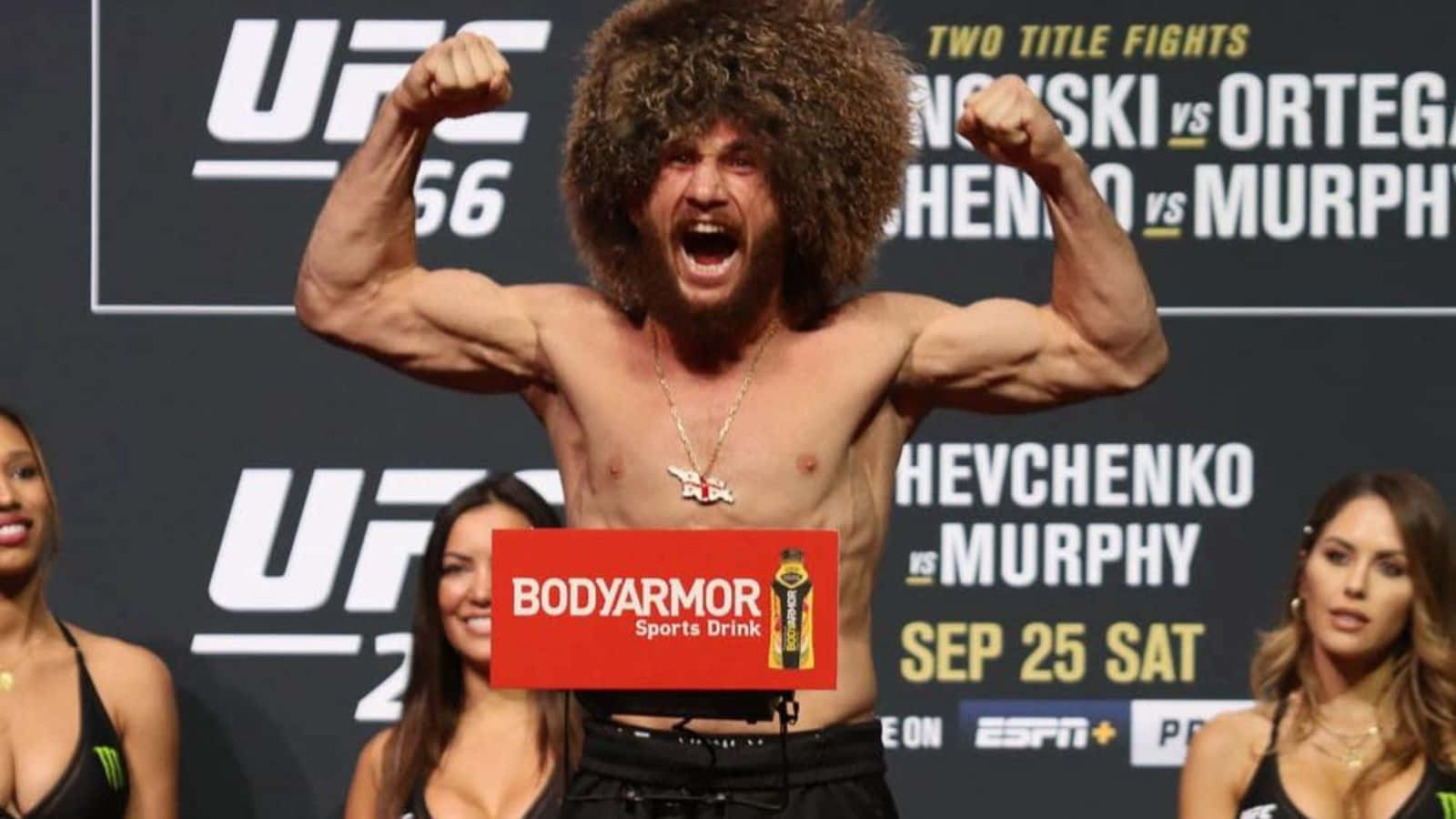 Merab Dvalishvili Showing His Muscles Background