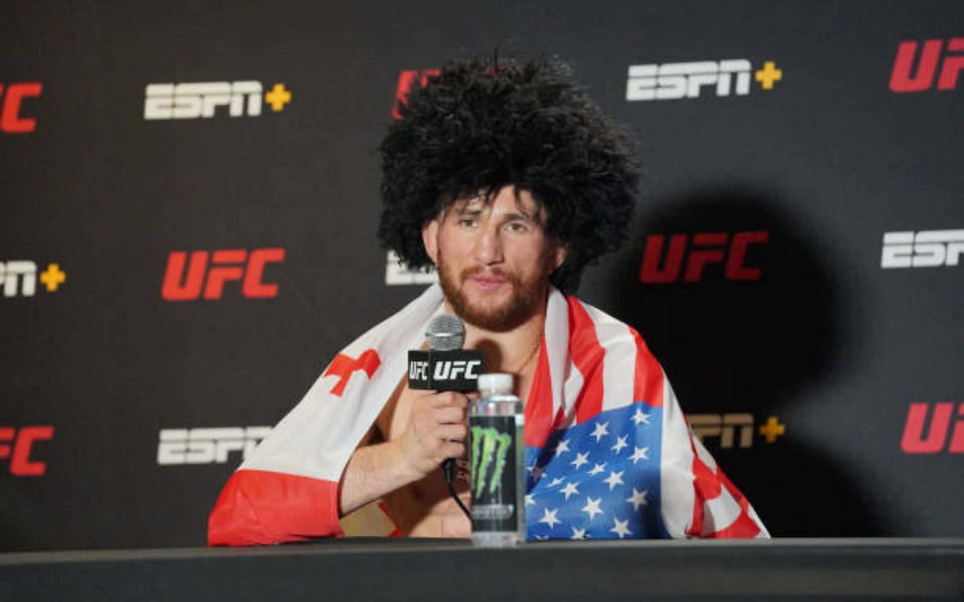 Merab Dvalishvili With An Afro Wig Background