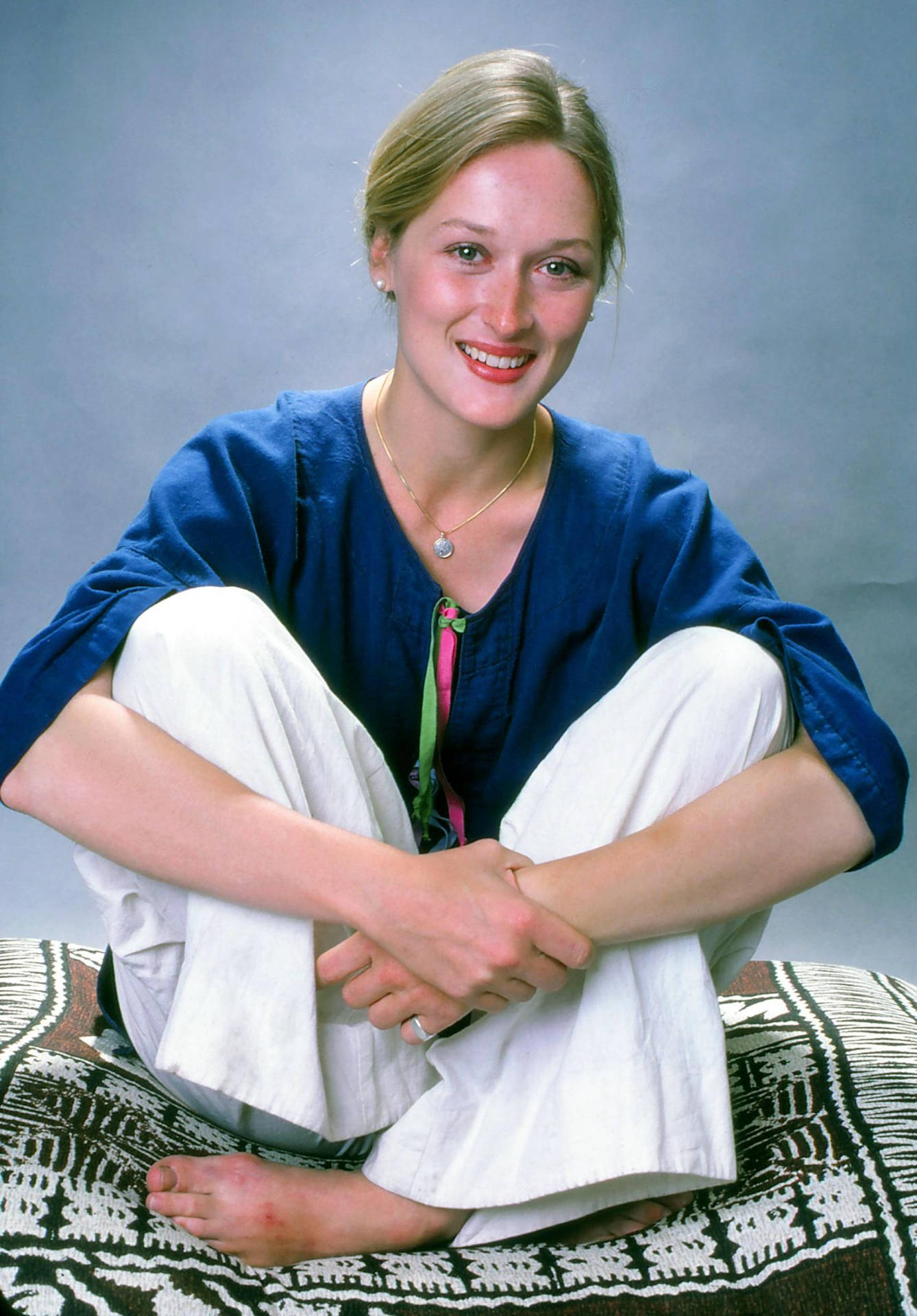 Meryl Streep Sitting On A Mat Background