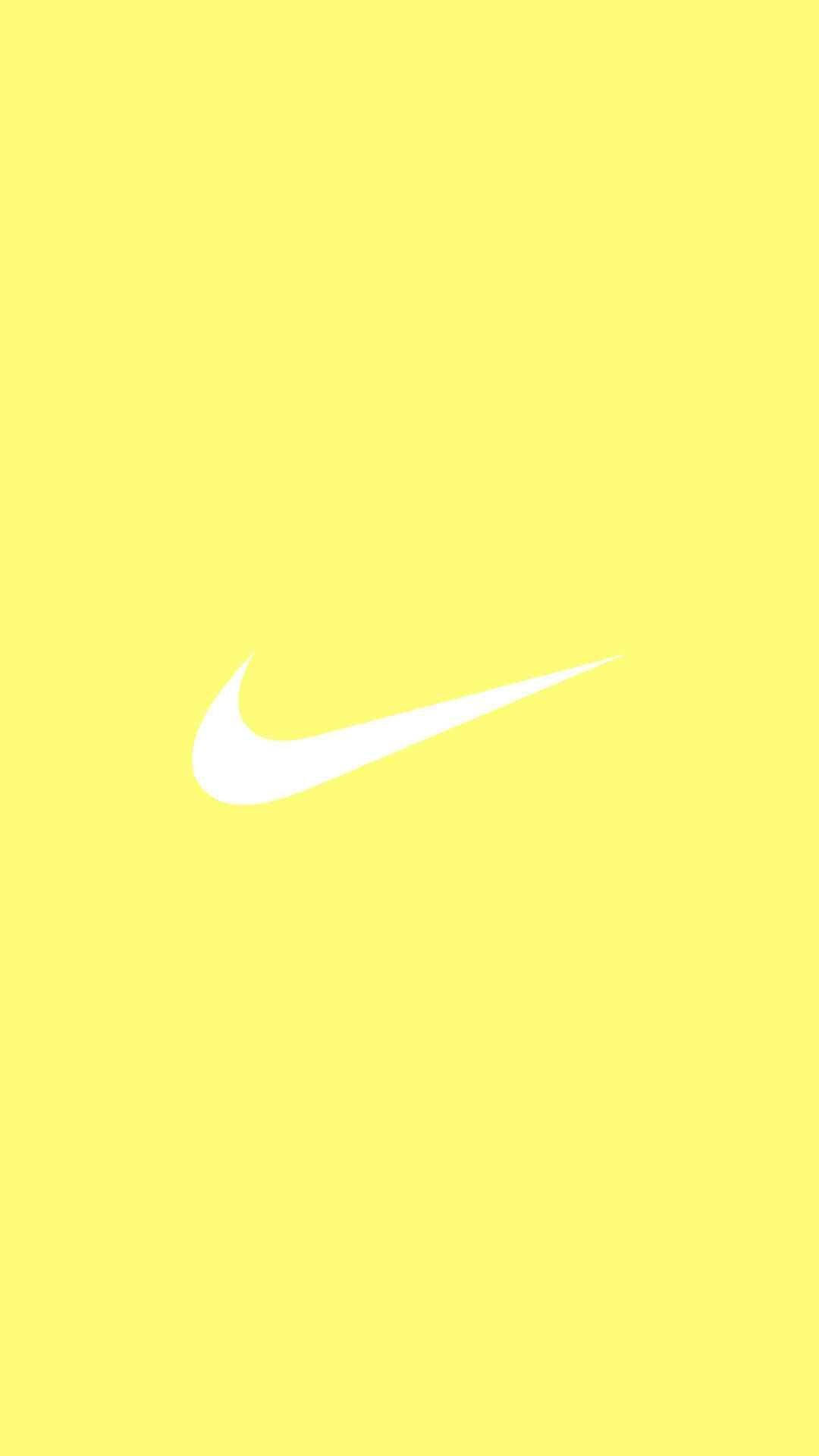 Mesmerizing Splash Of Cute Pastel Yellow Aesthetic With Iconic Nike Logo