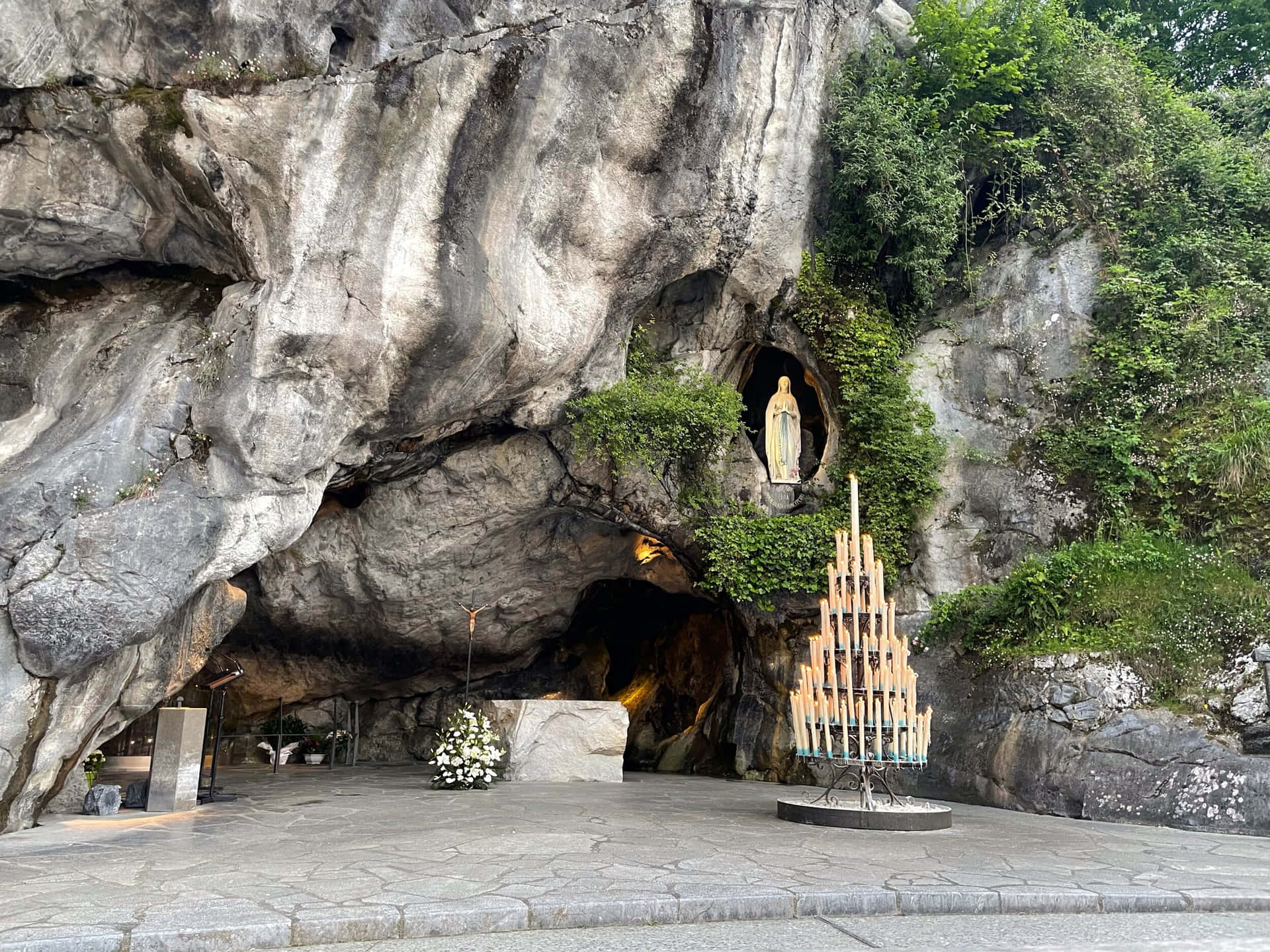 Mesmerizing View Of Lourdes Sanctuary At Dusk Background