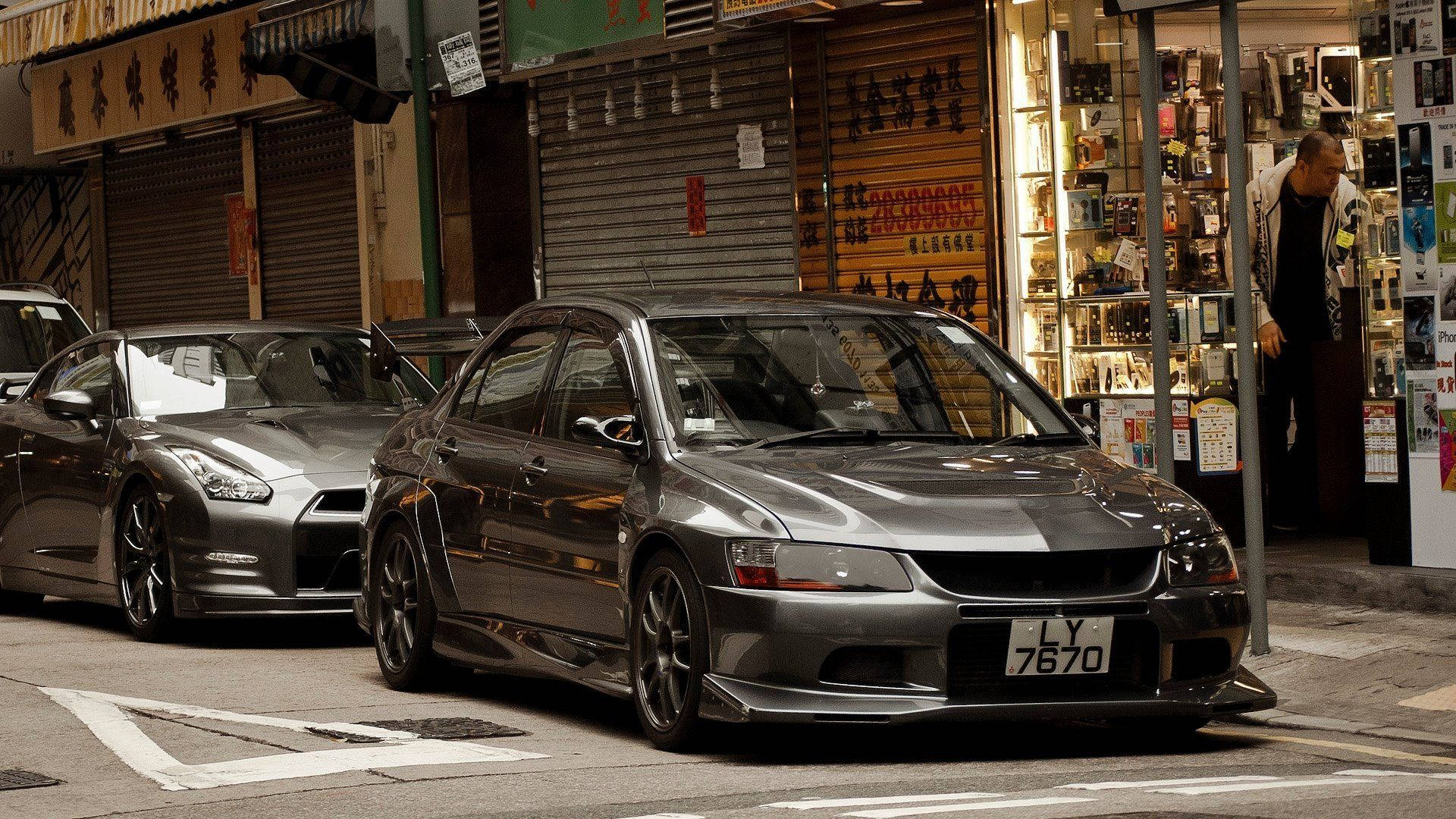 Metallic Gray Mitsubishi In Chinatown Background