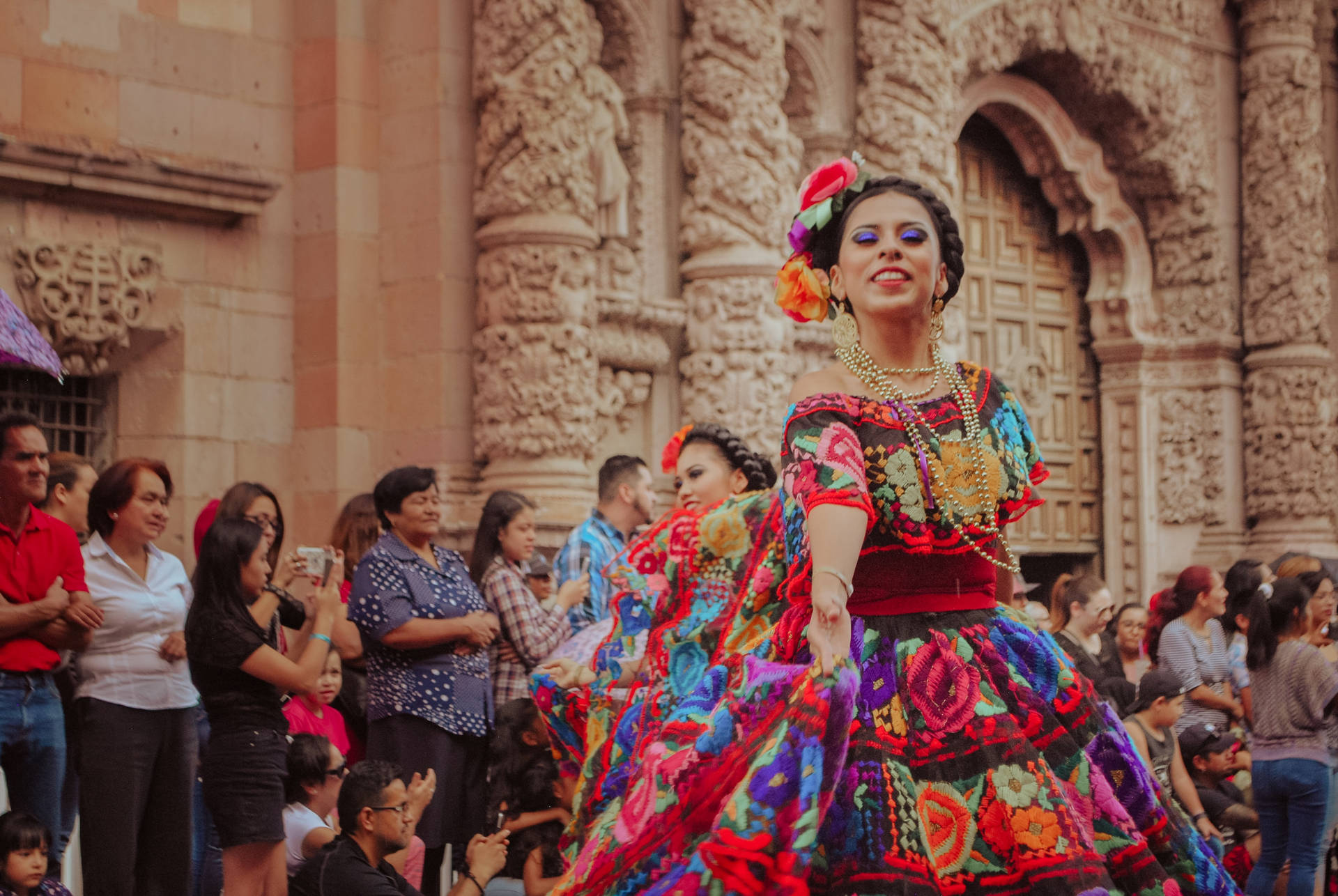 Mexican Man With Girl In Colorful Dress Background