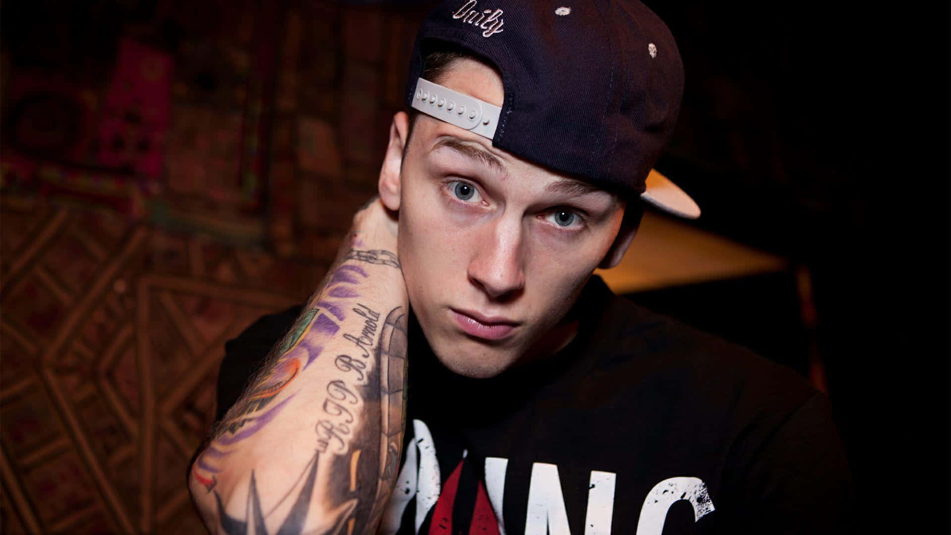 Mgk With Black Cap Background