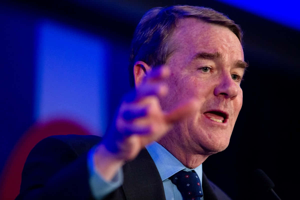 Michael Bennet Gesturing Towards Crowd Background