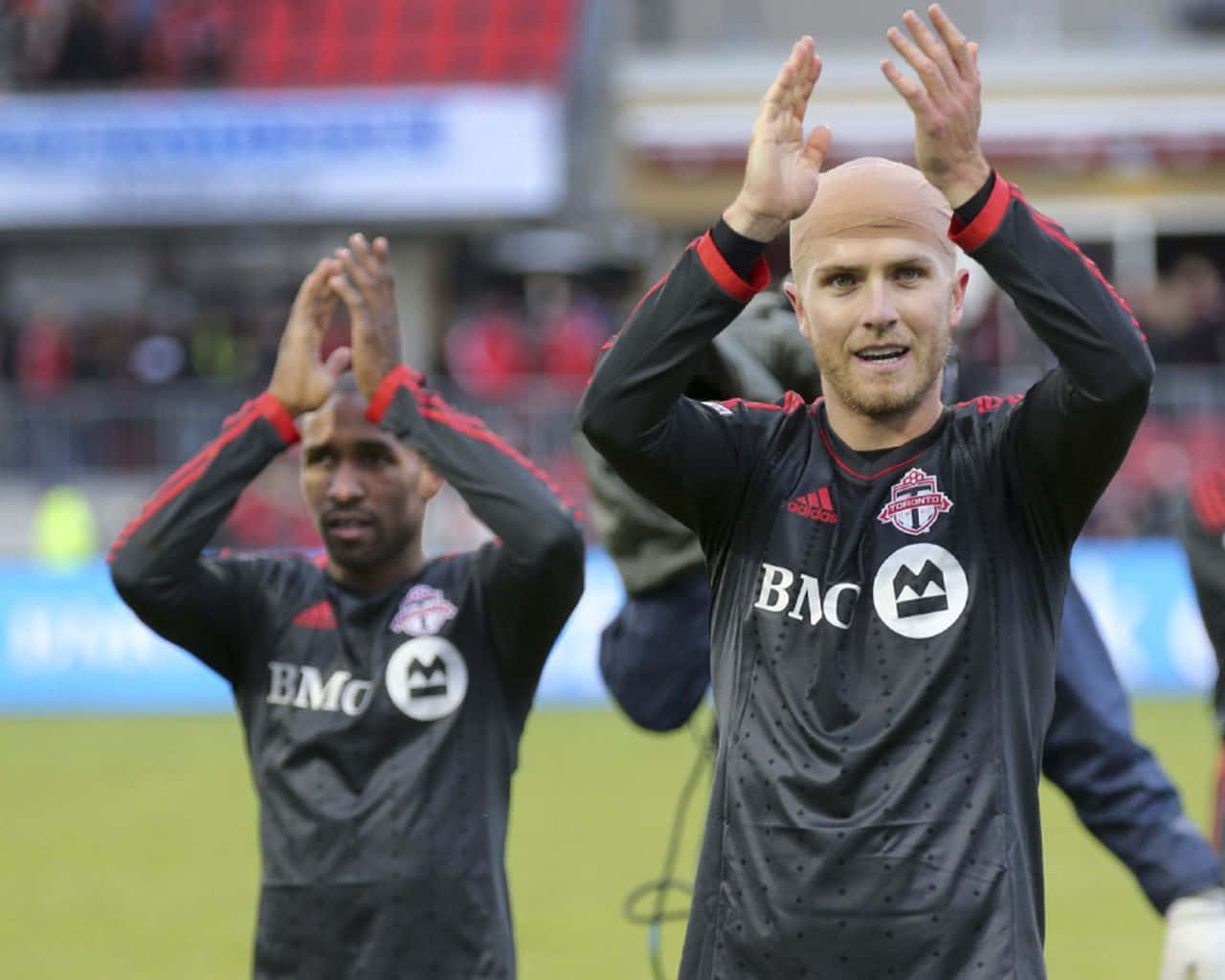 Michael Bradley Claps With Jermain Defoe Background