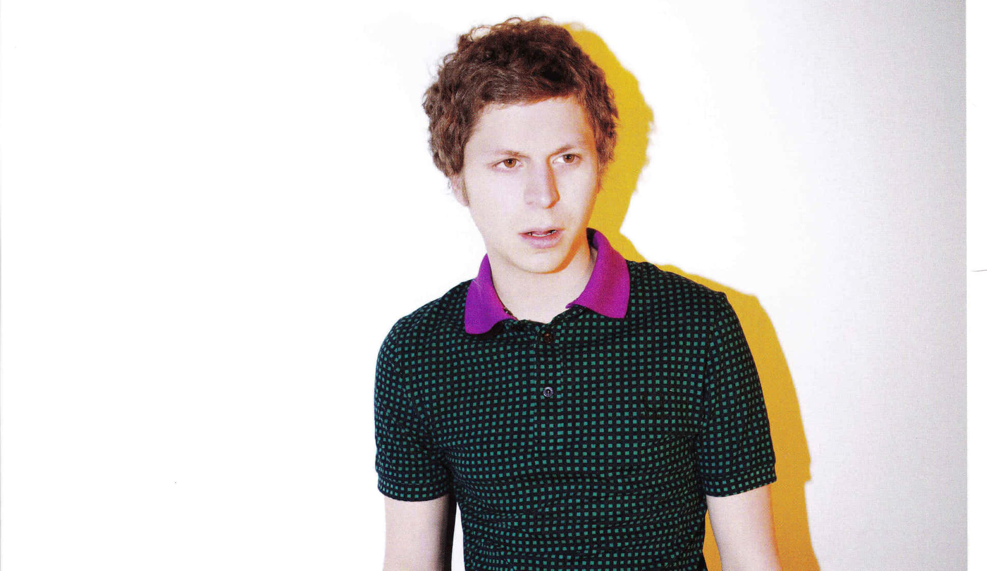 Michael Cera Poses With A Guitar Background