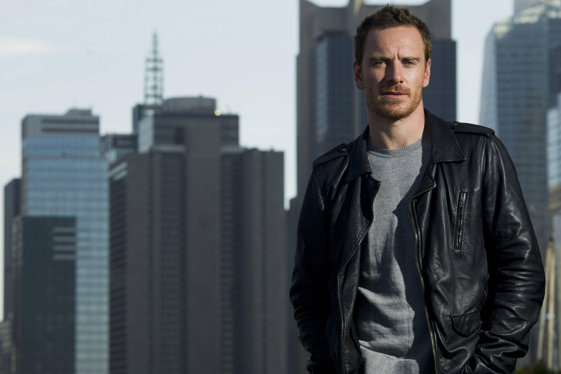 Michael Fassbender In A Cityscape Background