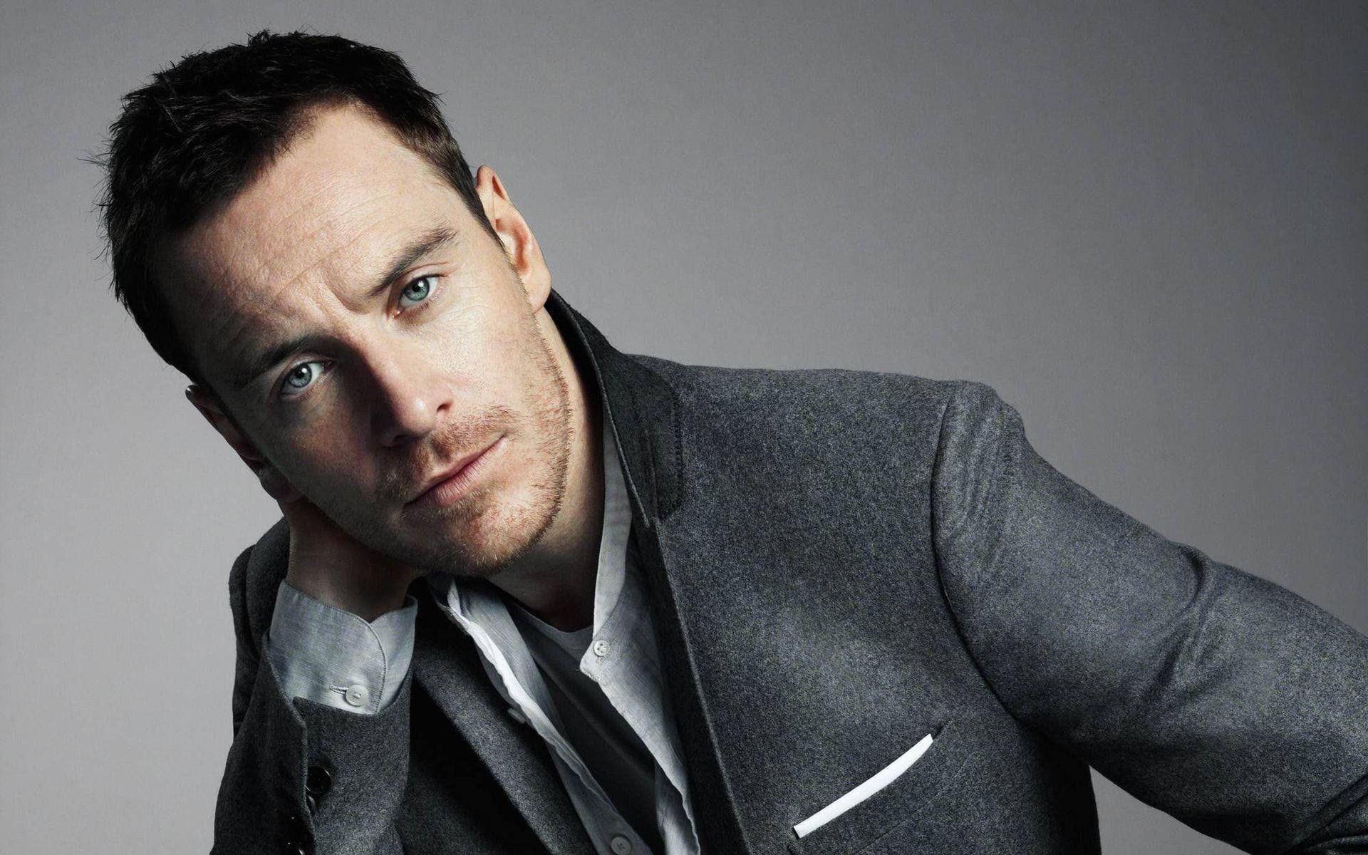 Michael Fassbender In Gray Suit Background
