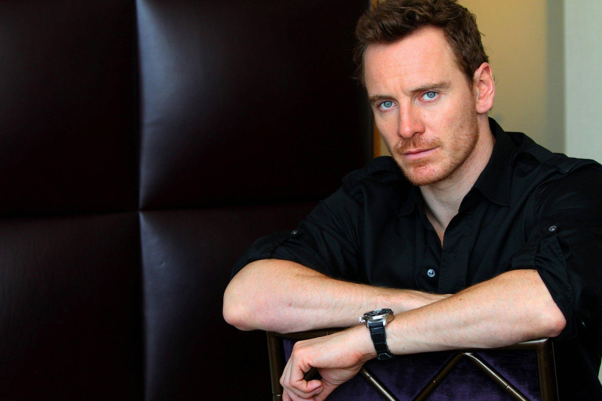 Michael Fassbender On Chair Background