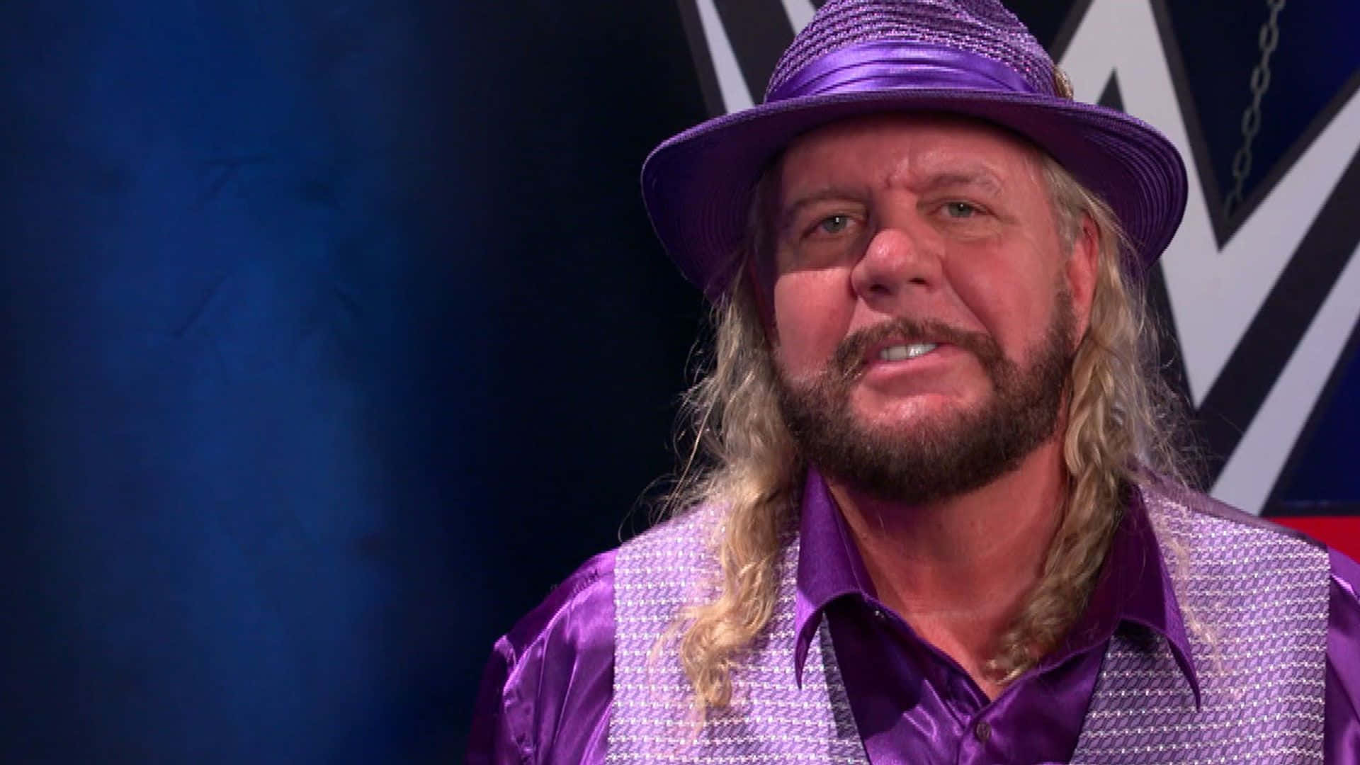Michael Hayesin Purple Hatand Jacket Background