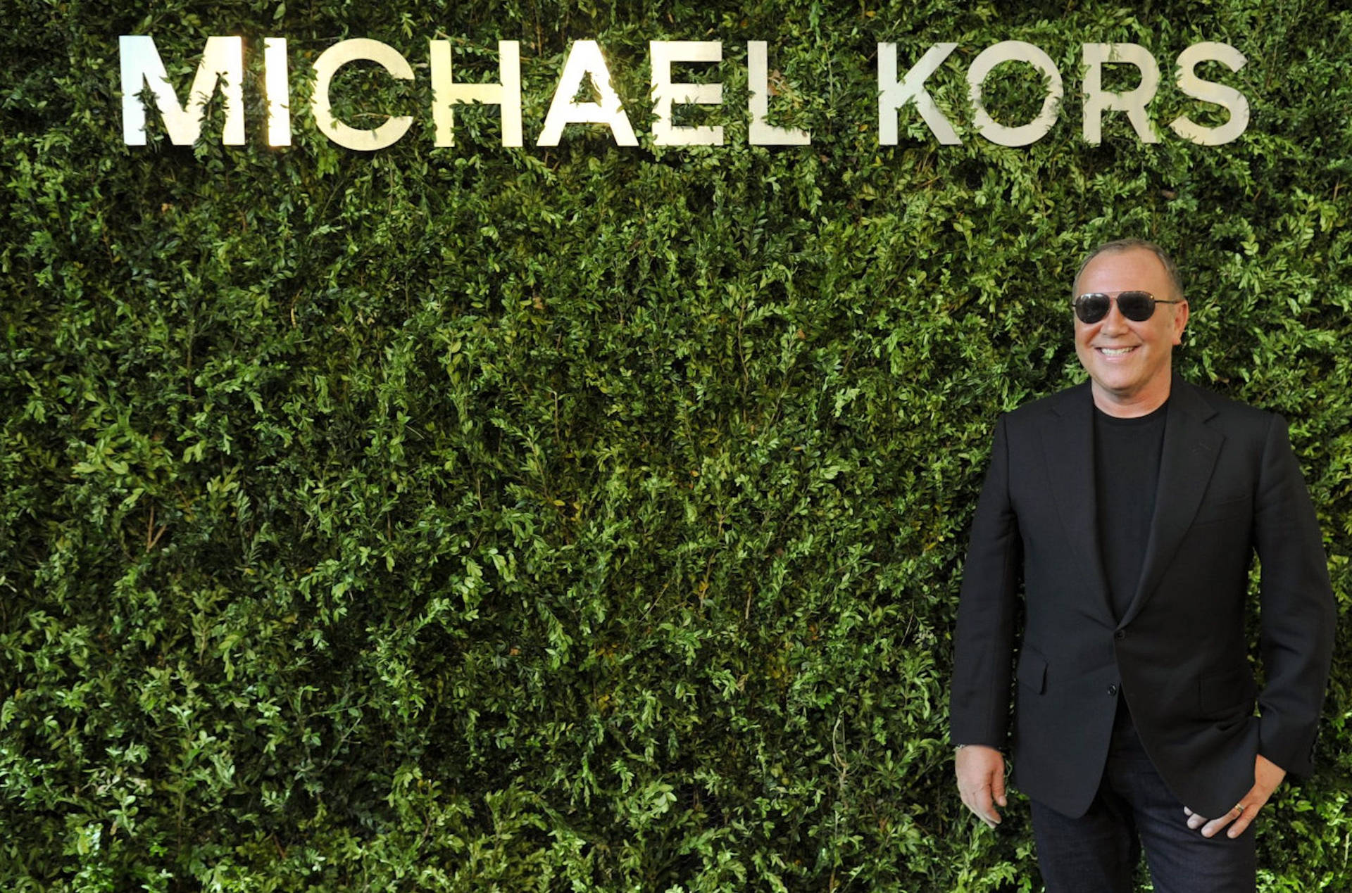 Michael Kors In All Black Outfit Background